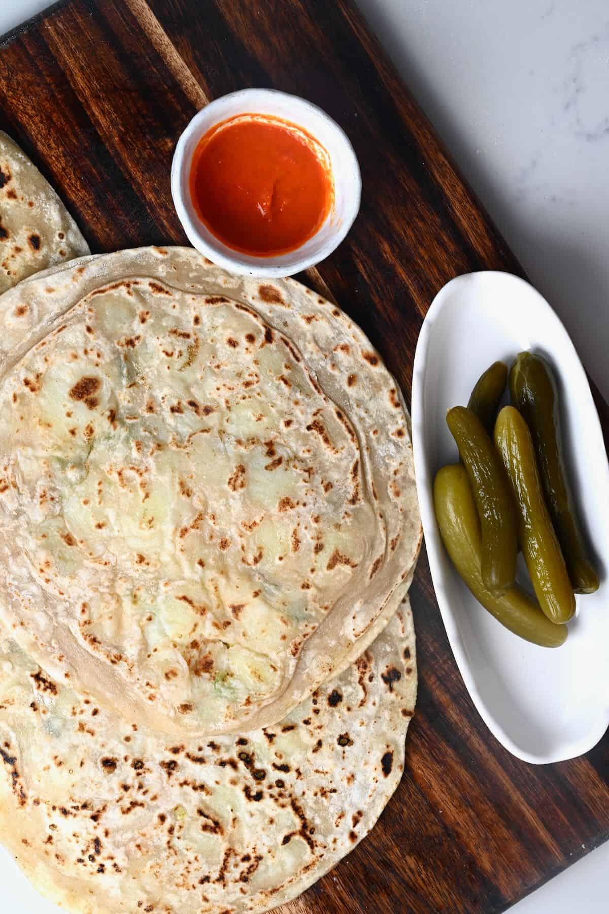 Homeamde aloo paratha with chili sauce and pickles