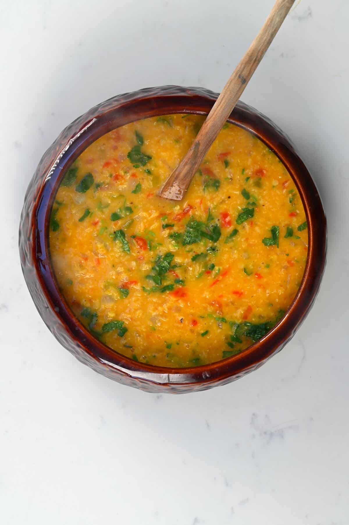Red lentil dahl in a serving bowl