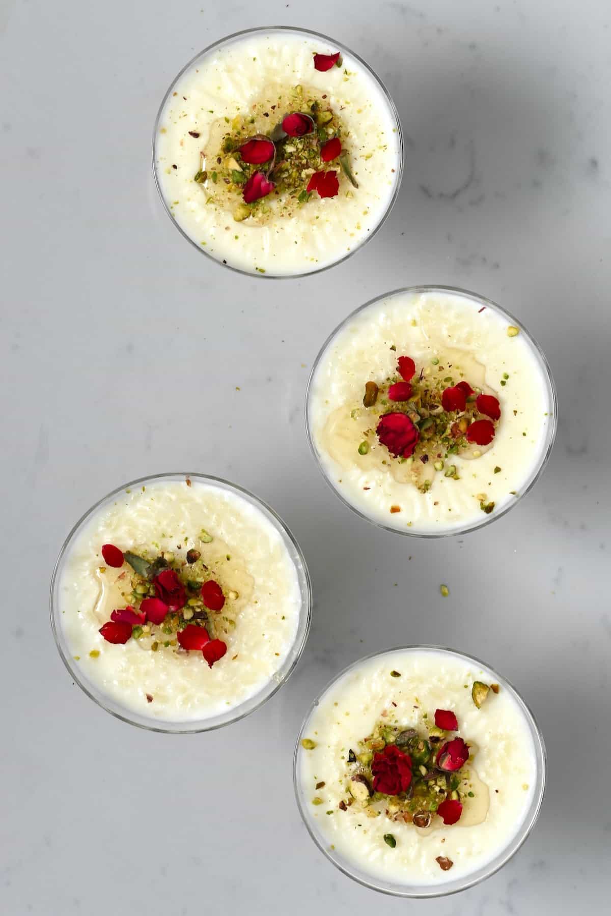Rice pudding topped with pistachio and rose petal