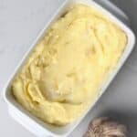 A container with roasted garlic butter