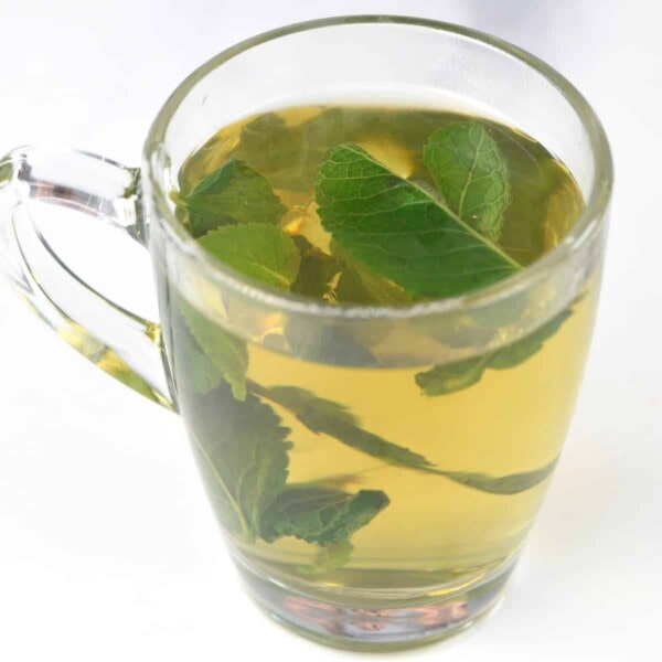 A glass with mint tea and mint leaves