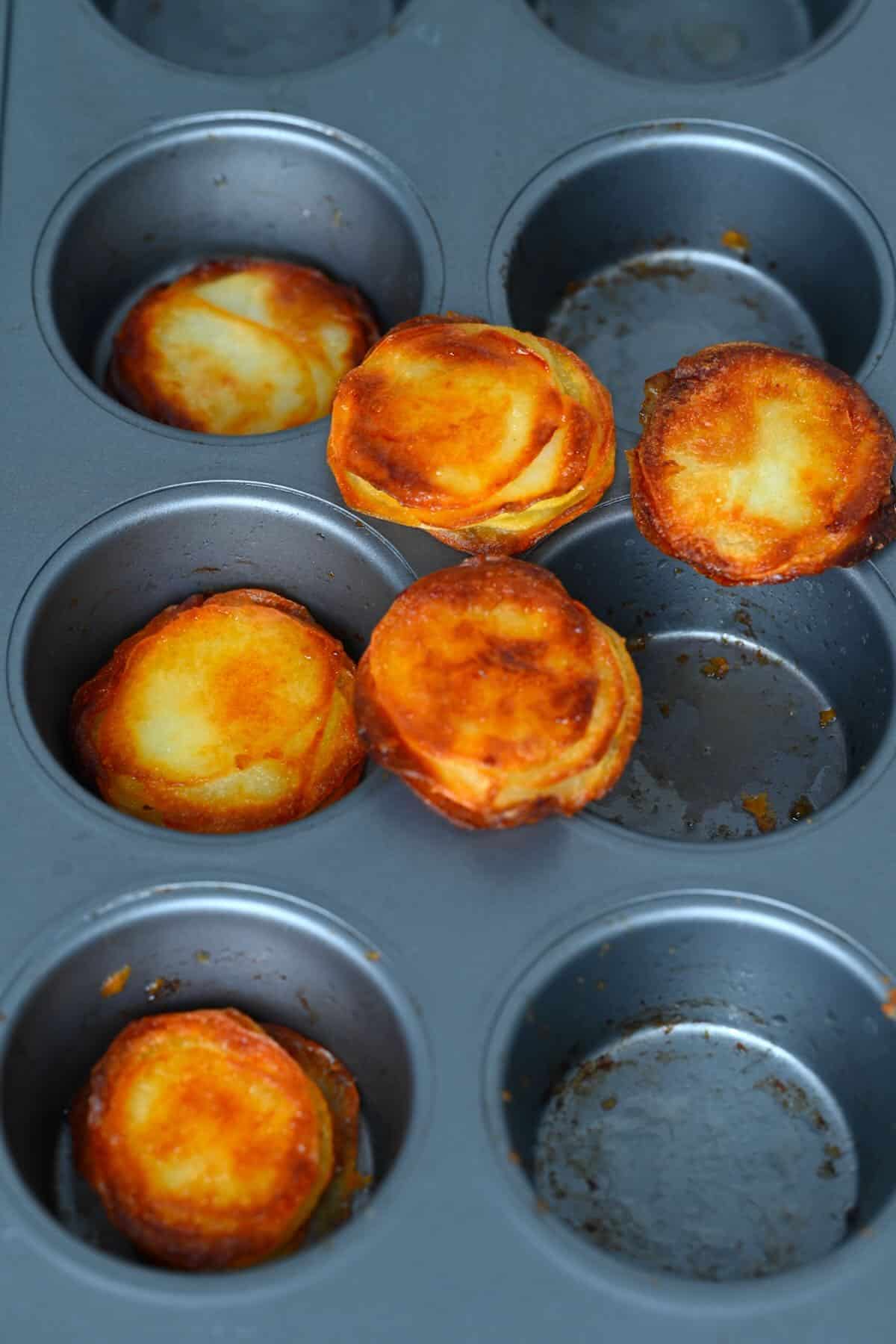 Crispy cheesy potato stacks in a muffing tray