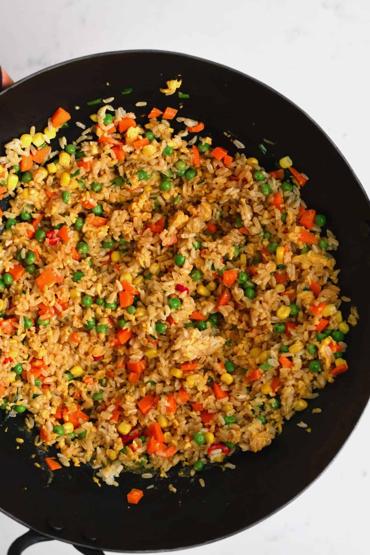 Egg fried rice in a large pan