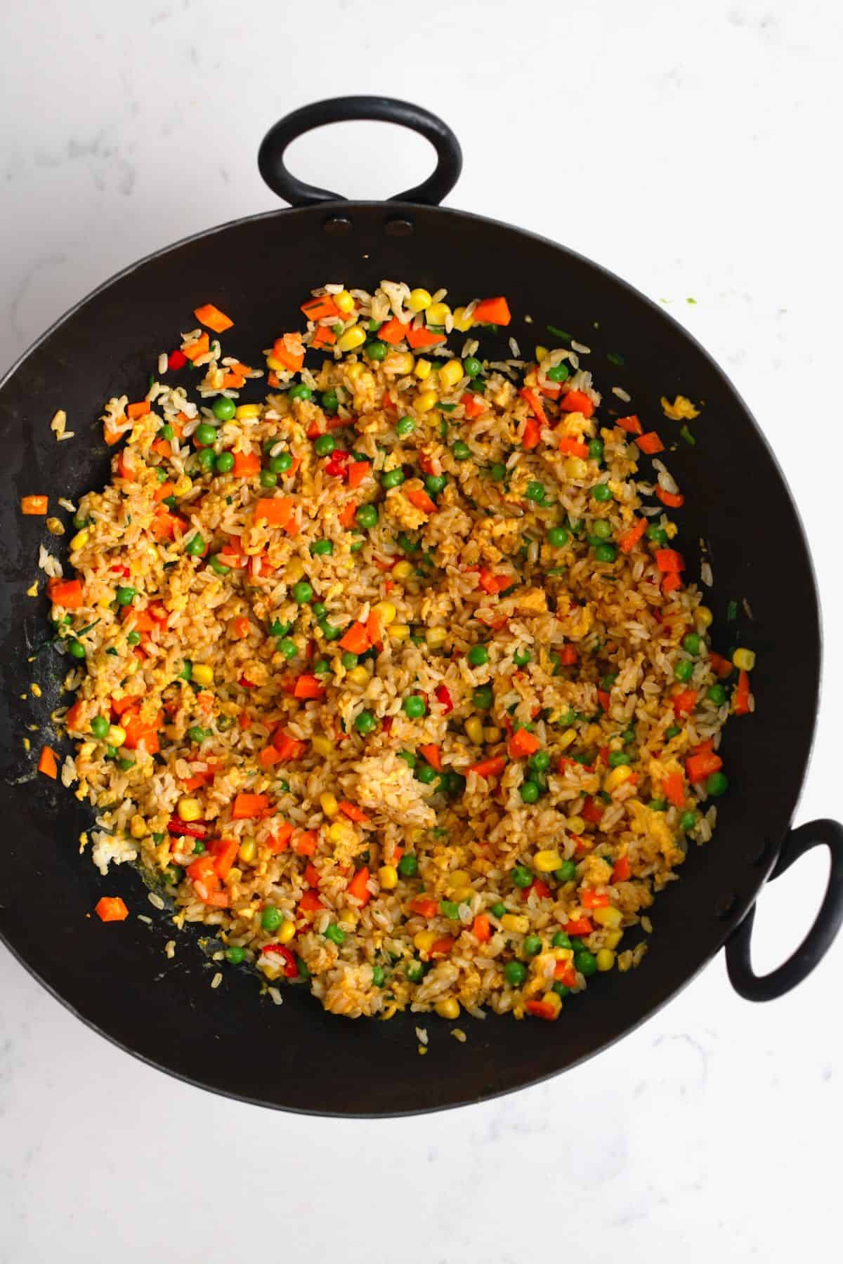 Egg fried rice in a large pan