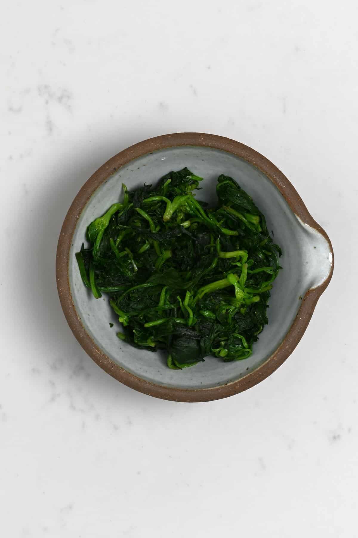 Cooked spinach in a bowl