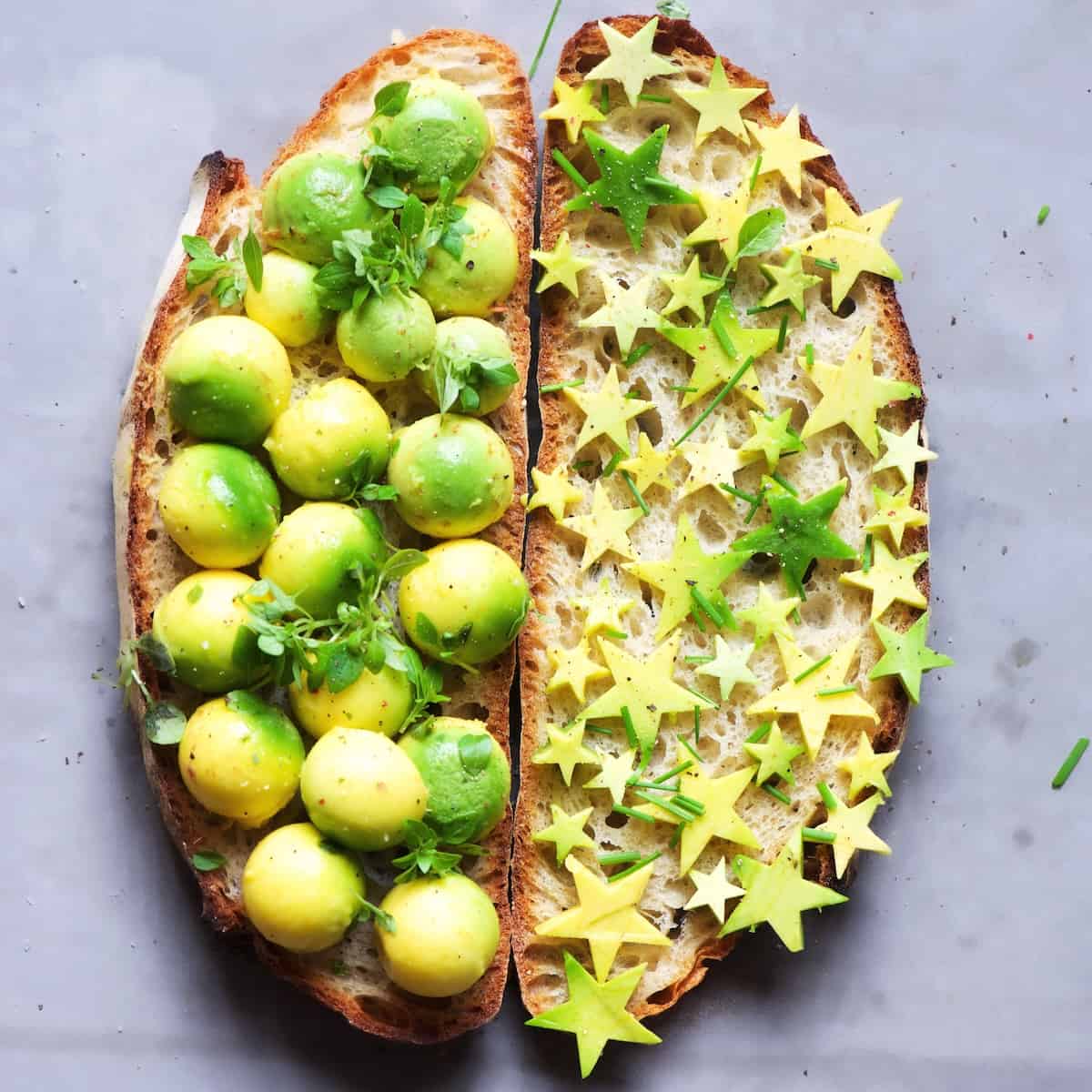 Two slices of bread with avocado on top