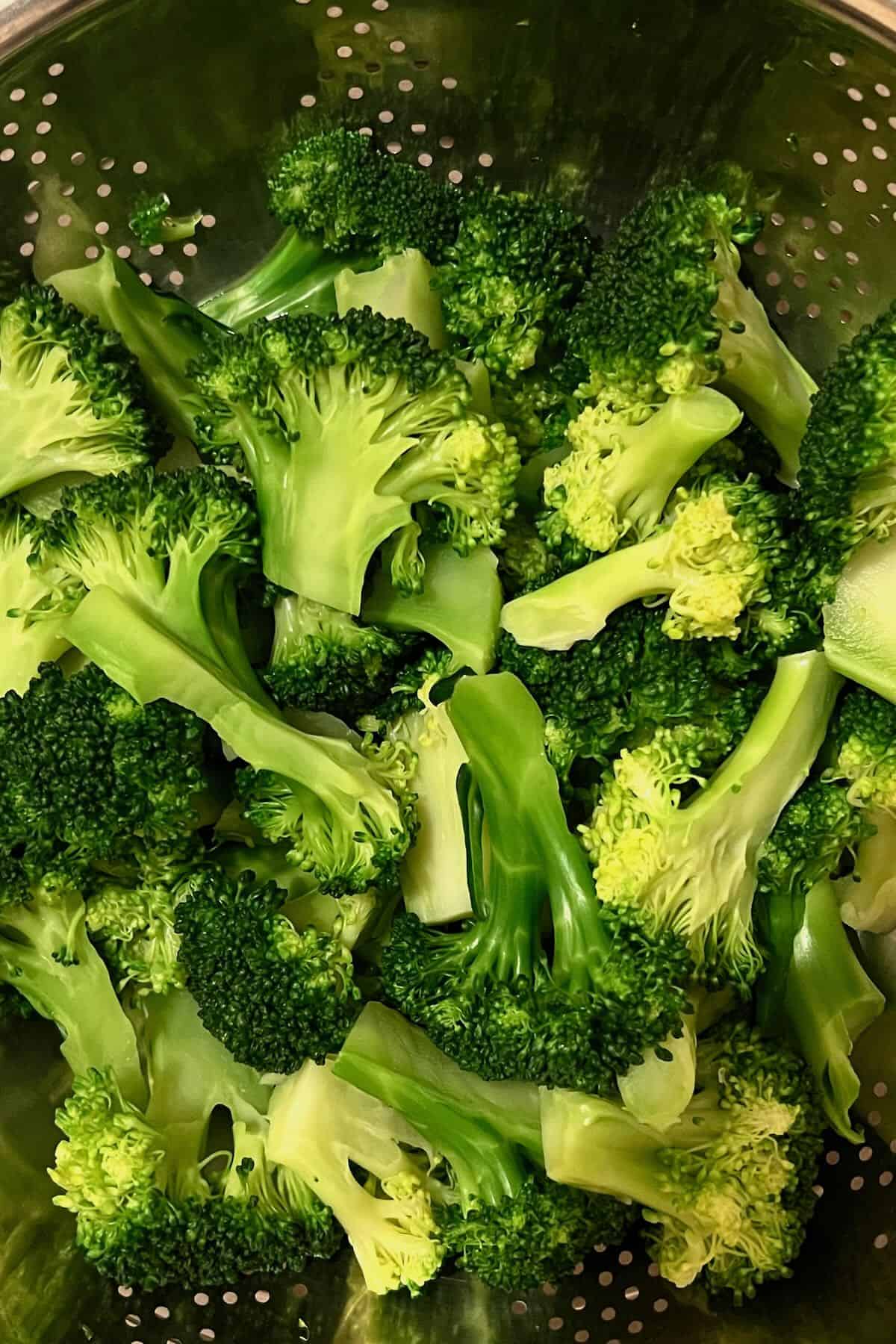 Blanched broccoli in a colander