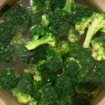 Blanched broccoli in a bowl with water