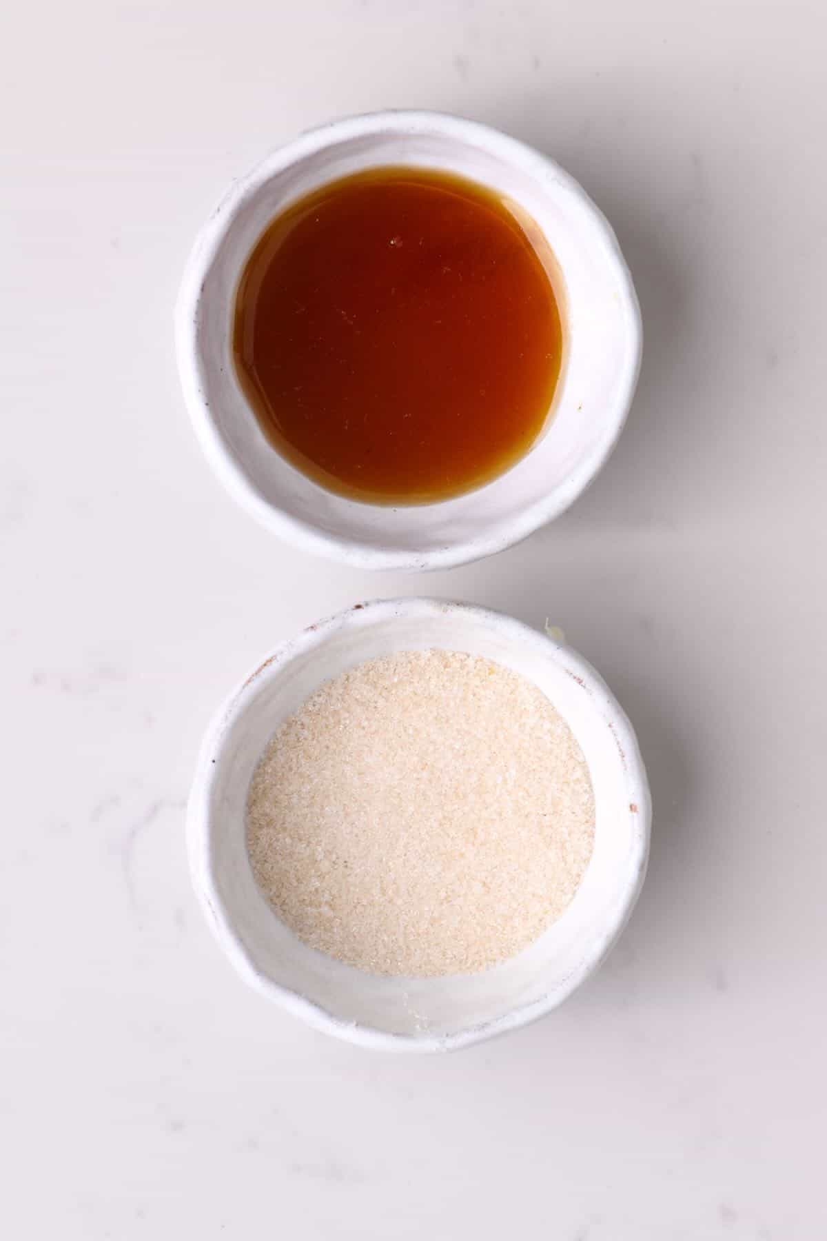 Granulated sugar and liquid sweetener in bowls
