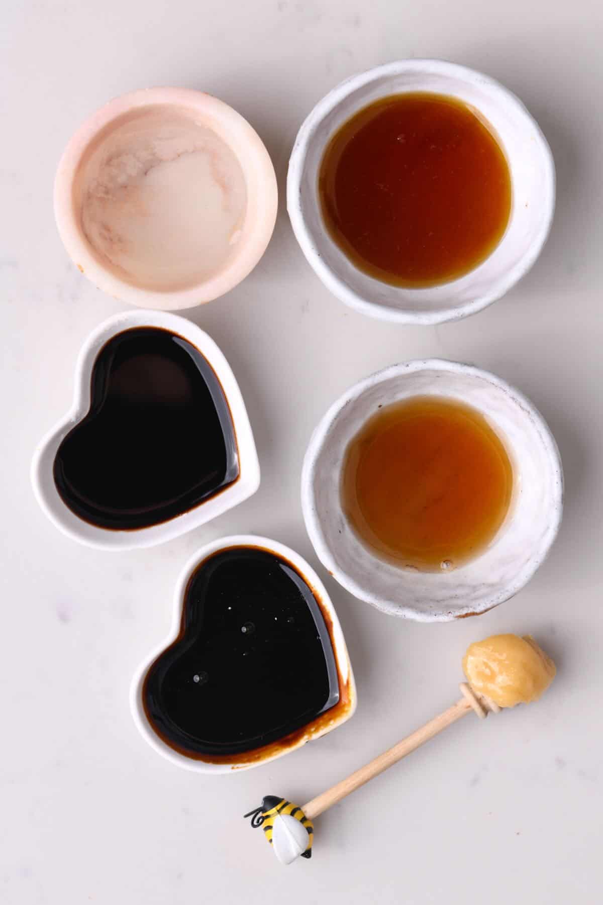 Small bowls with different liquid sweeteners