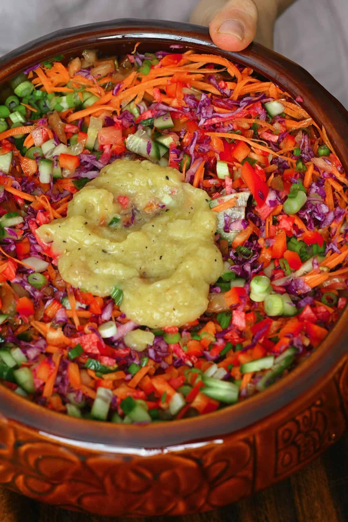 Rainbow cabbage salad topped with roasted garlic dressing