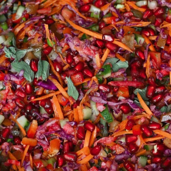 Rainbow cabbage salad topped with herbs