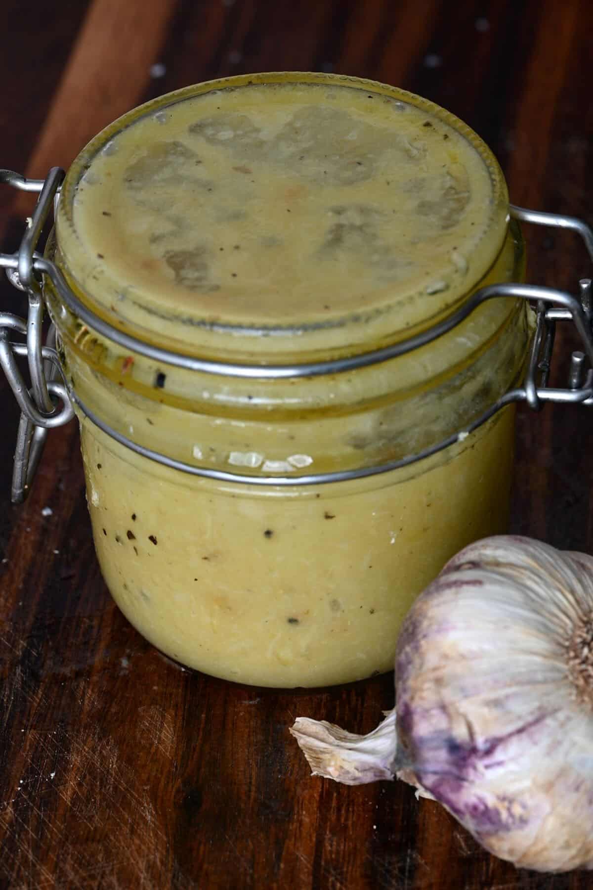 A jar with roasted garlic dressing