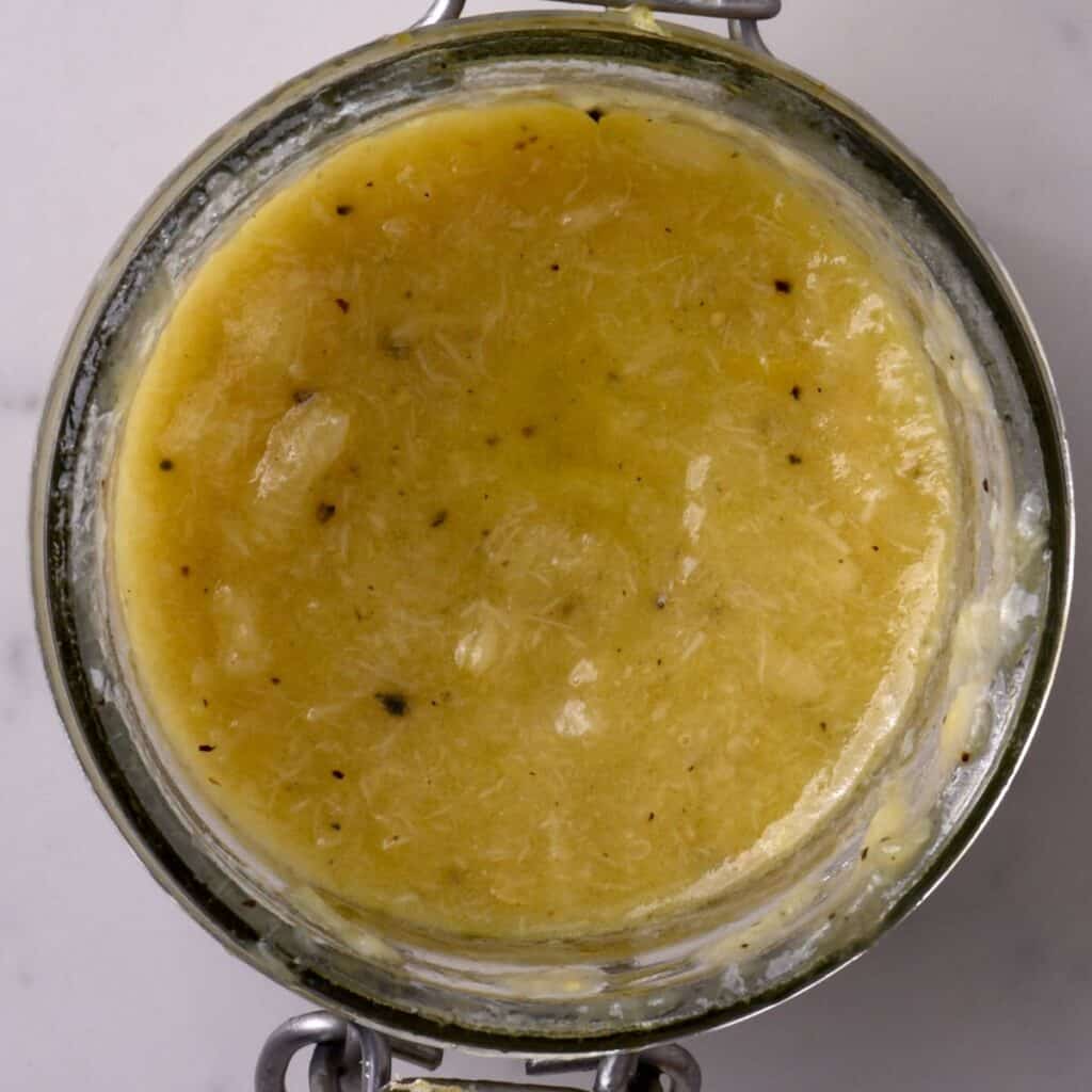 A jar with roasted garlic dressing