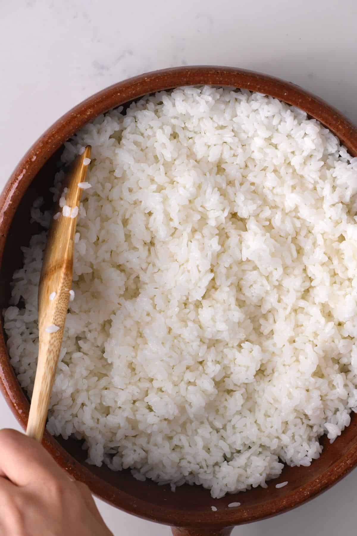 Mixing sushi rice in a bowl