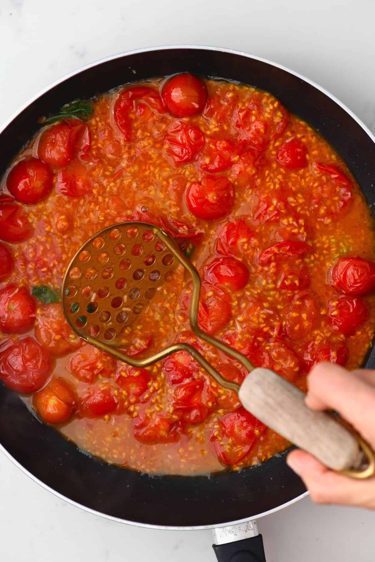 Mashing cooked tomatoes