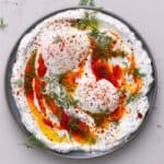 Turkish eggs topped with dill in a plate - 15