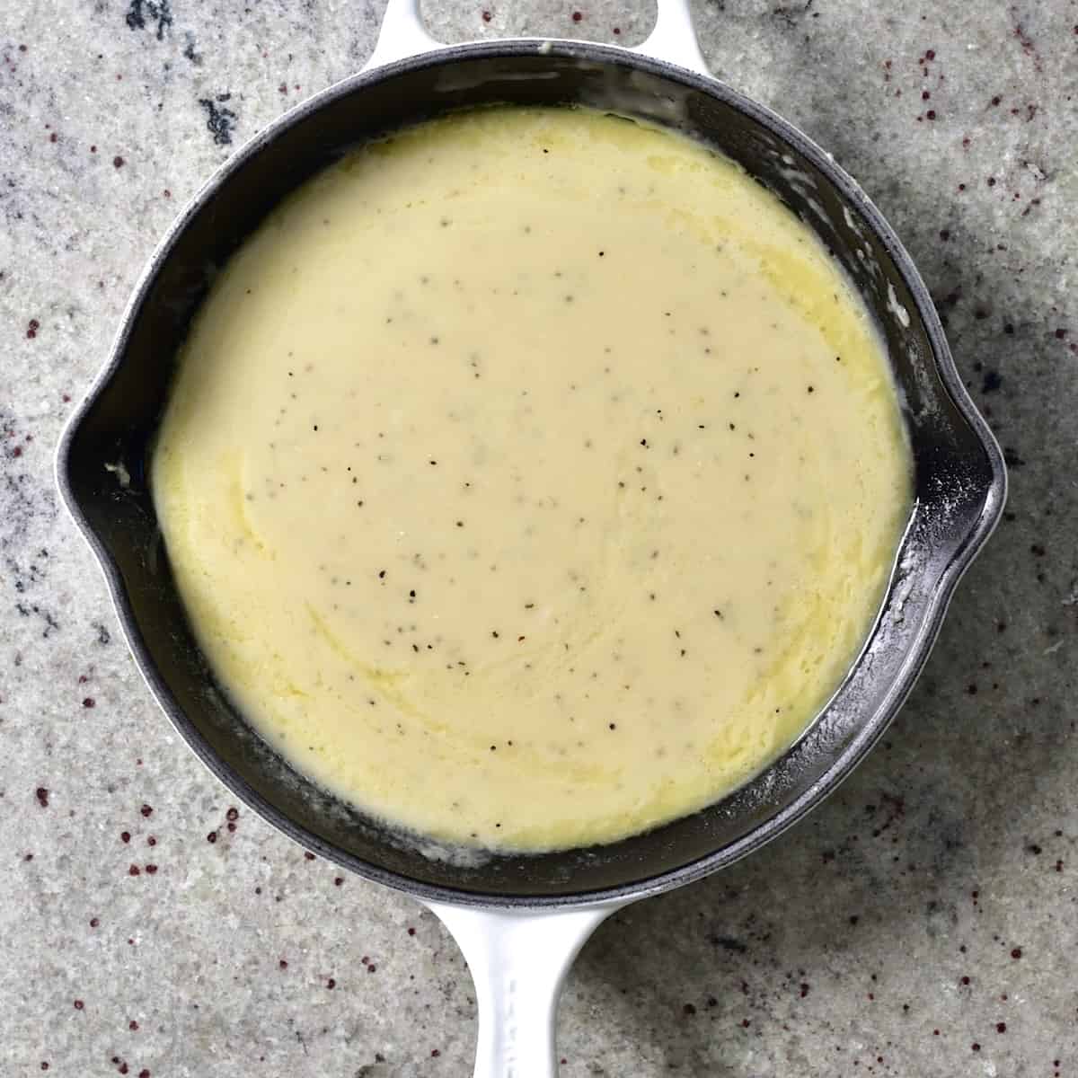 A saucepan with garlic cream sauce