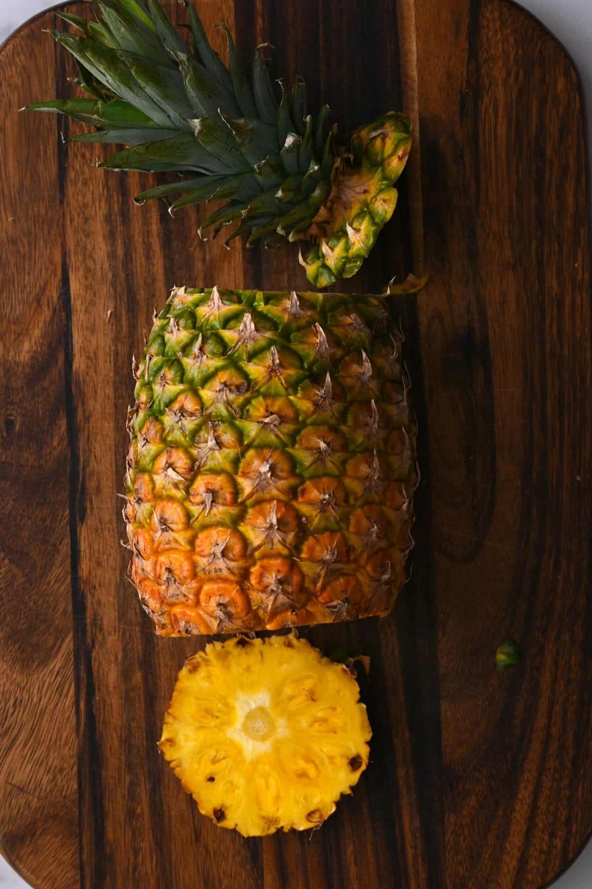 A pineapple with the crown and bottom cut off