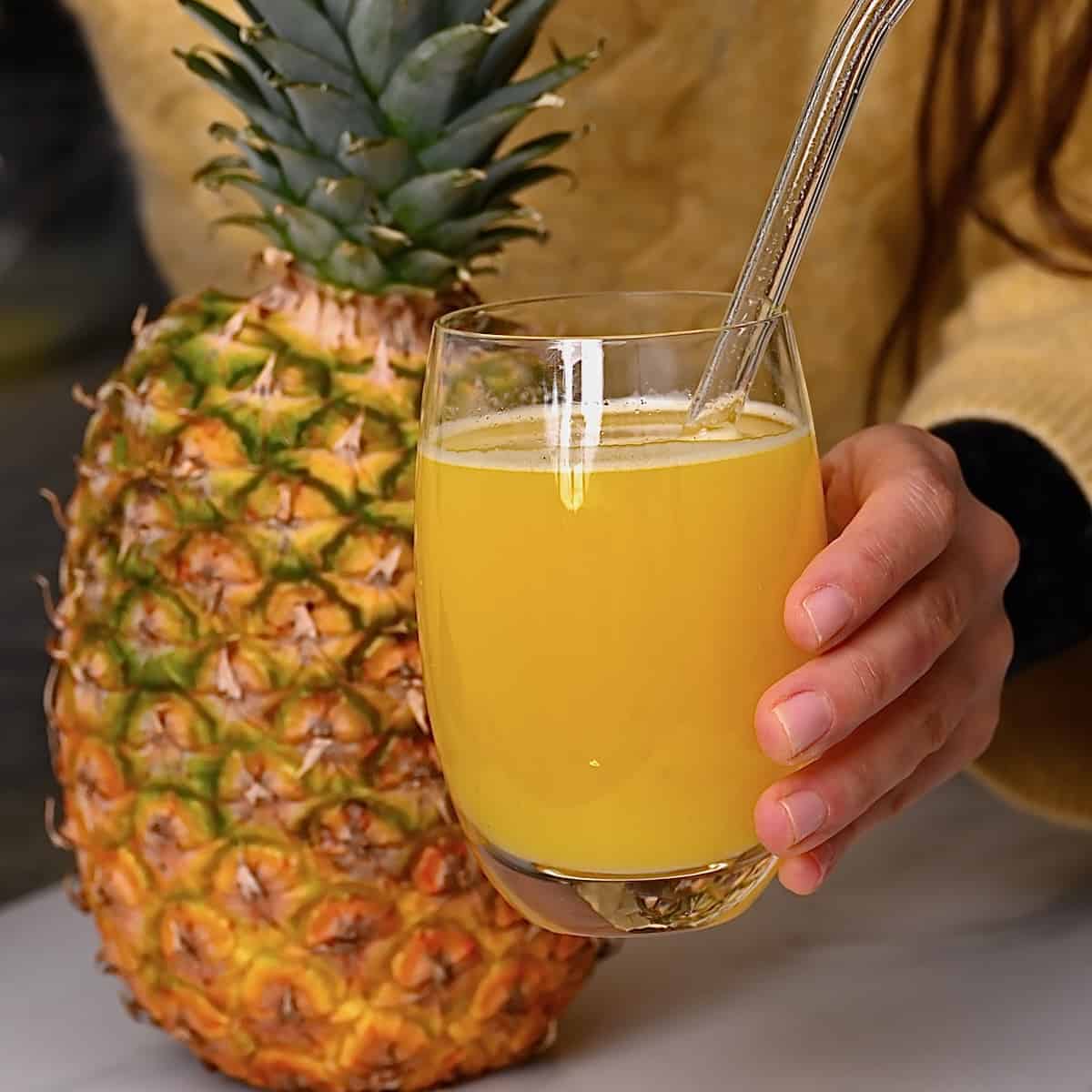 Pineapple juice in a glass and a pineapple