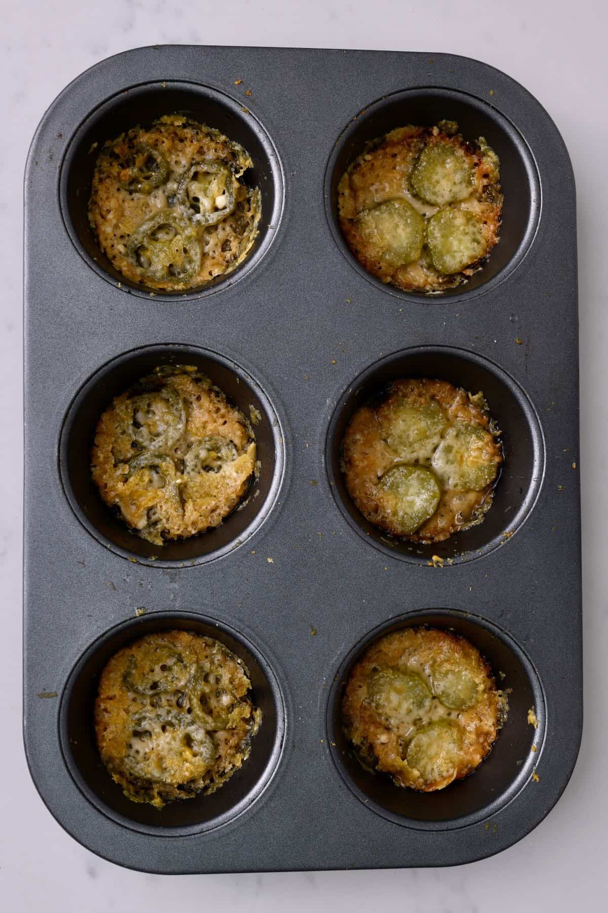 Muffin tray with freshly baked parmesan crisps