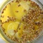 Top view of jar with preserved lemons with coriander seeds