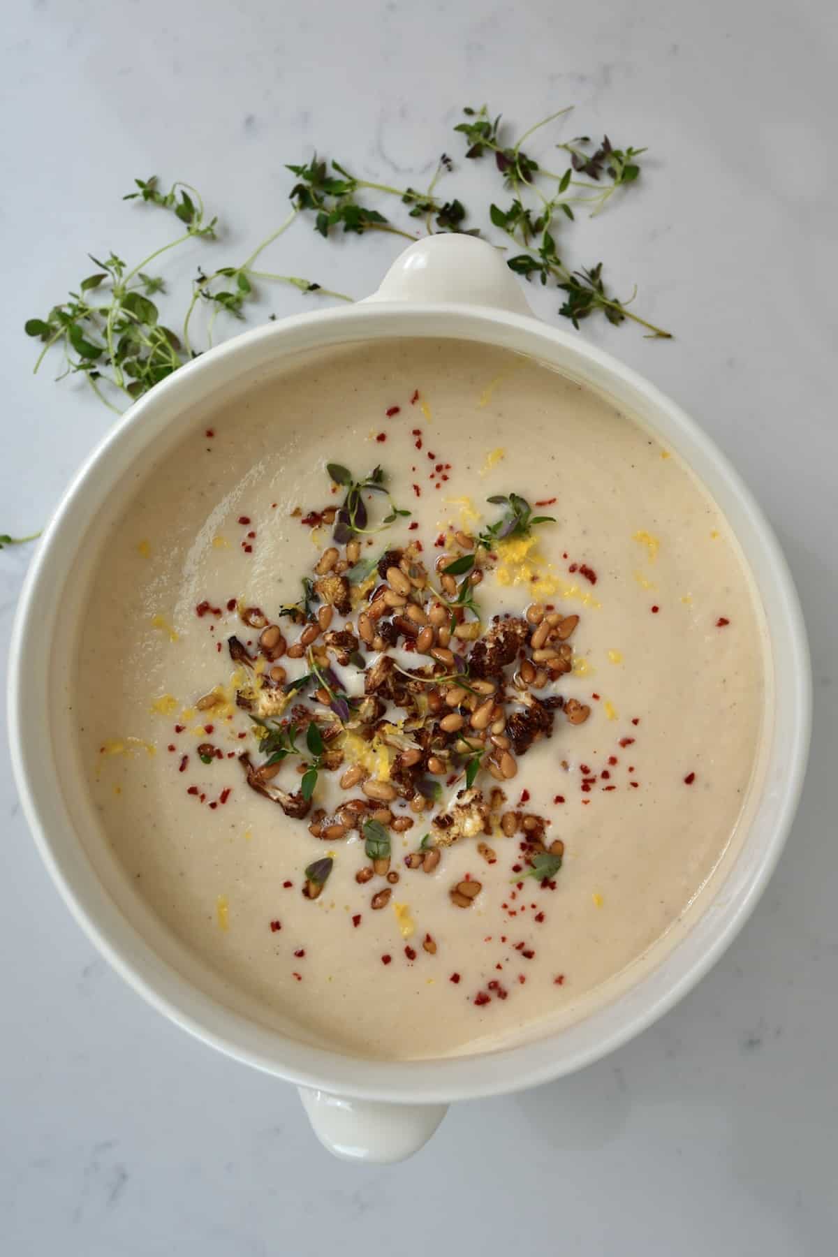 A serving bowl with cauliflower soup