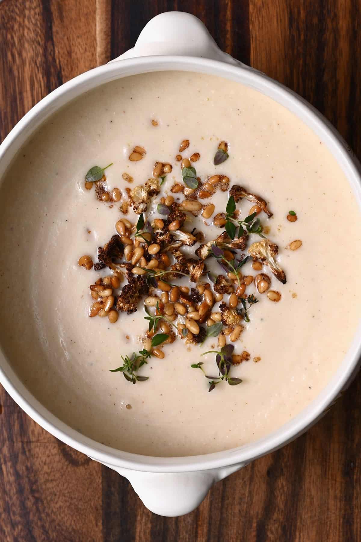 Cauliflower soup topped with pine nuts