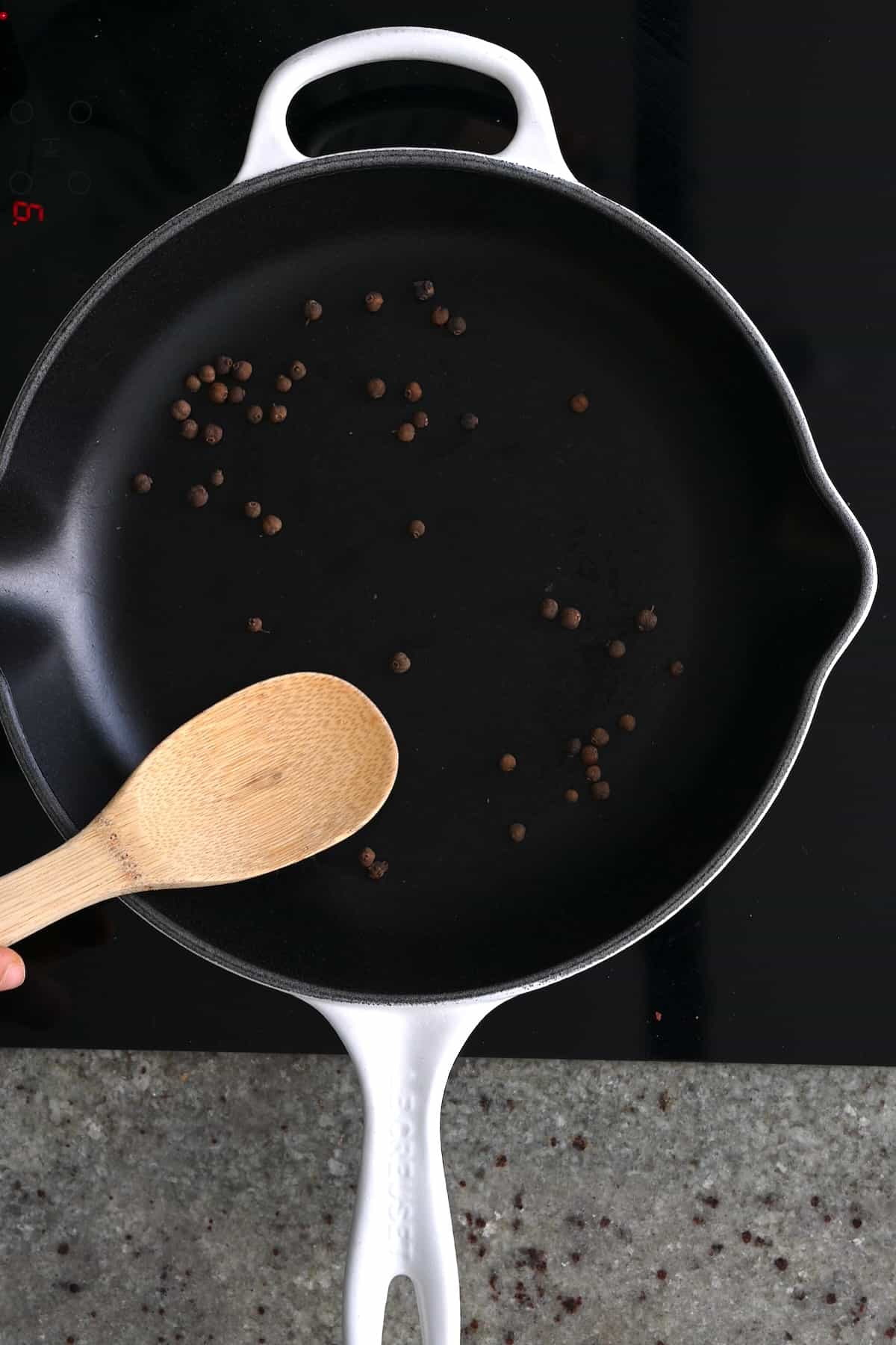 Toasting peppercorns on a pan