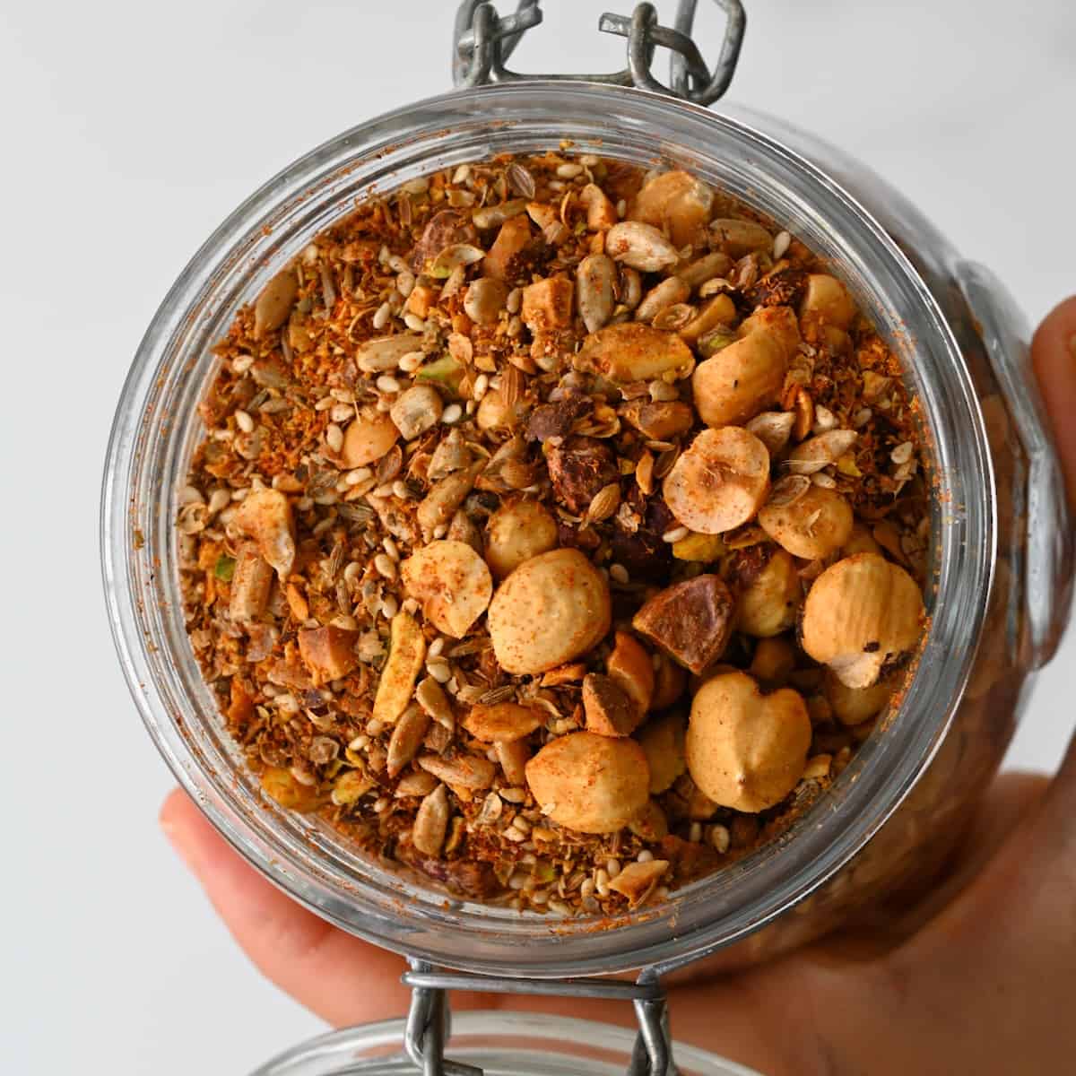 A jar with homemade dukkah spice and nut mix