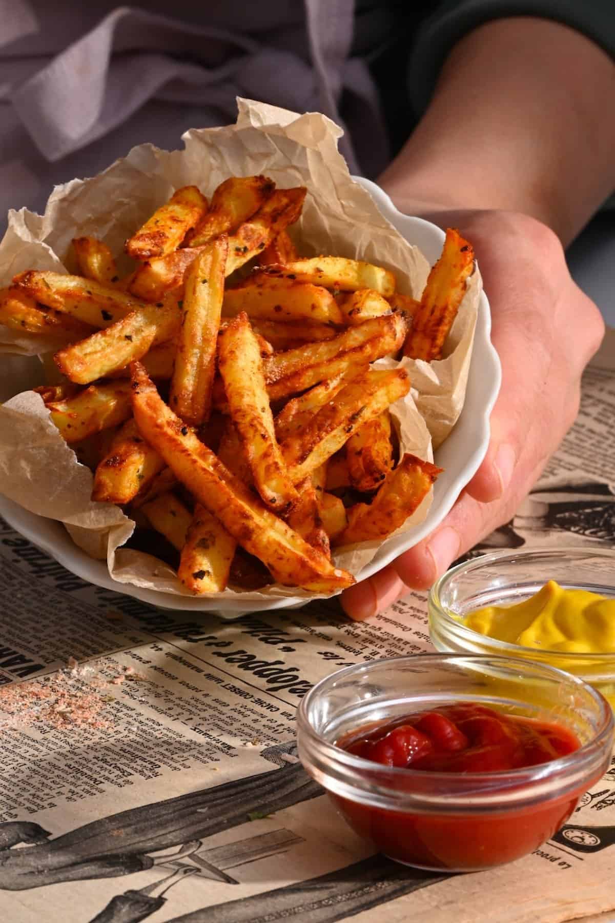 French fries with seasoning and ketchup and mustard