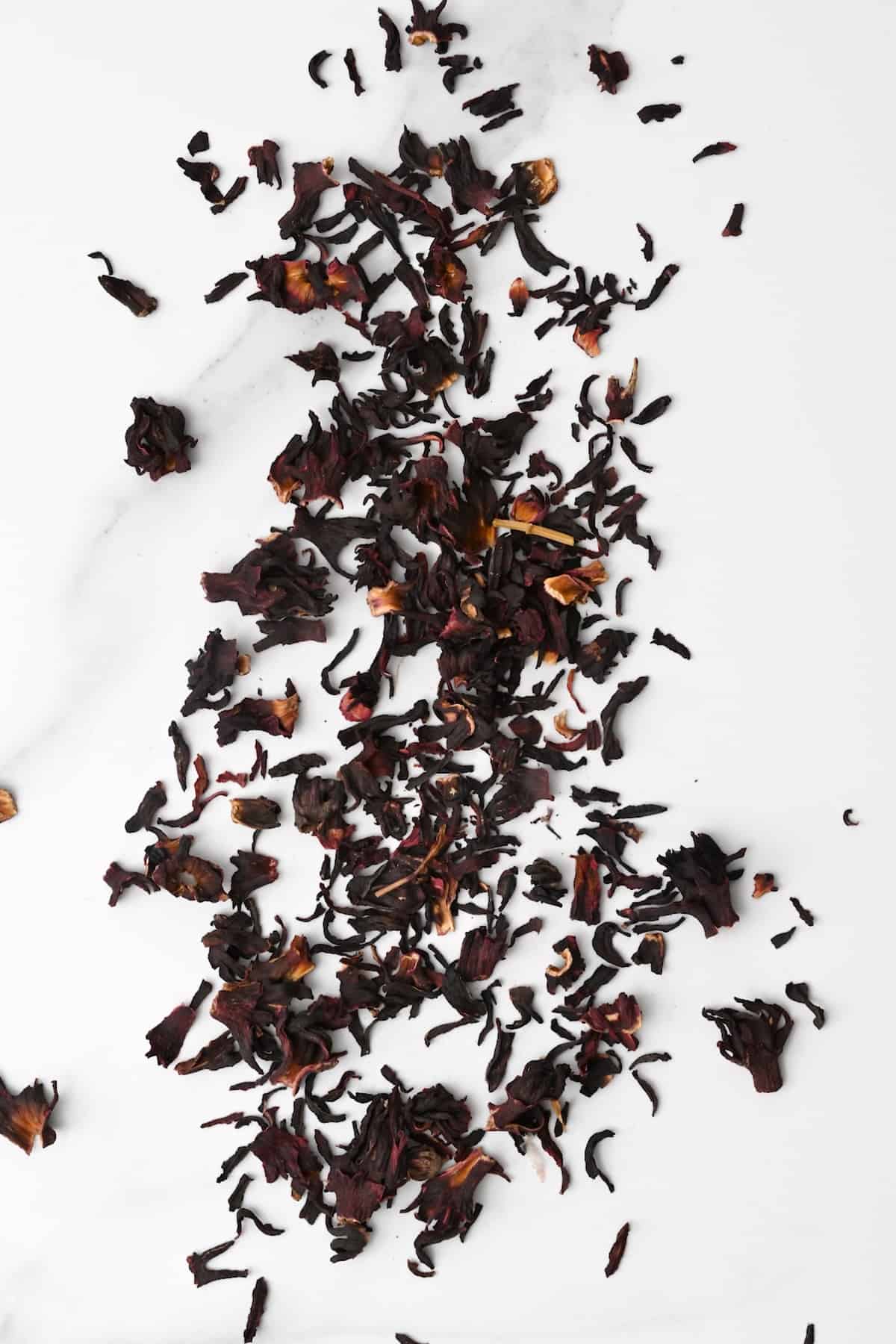 Dried hibiscus leaves spread on a flat surface