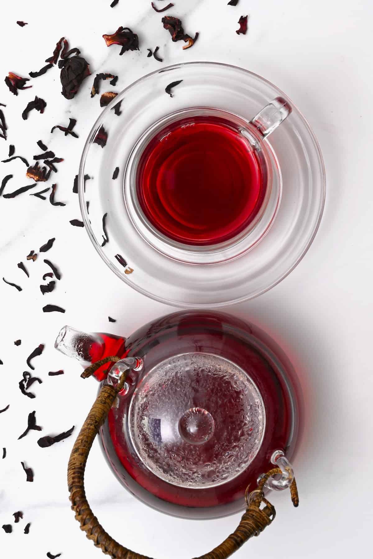 Top view of a kettle and cup with hibiscus tea