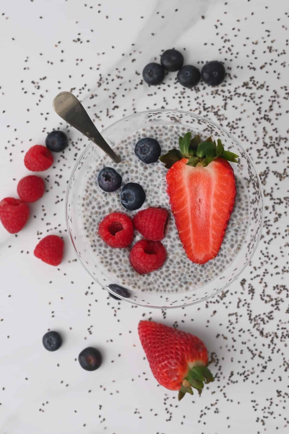 Chia pudding in a bowl topped with mixed berries