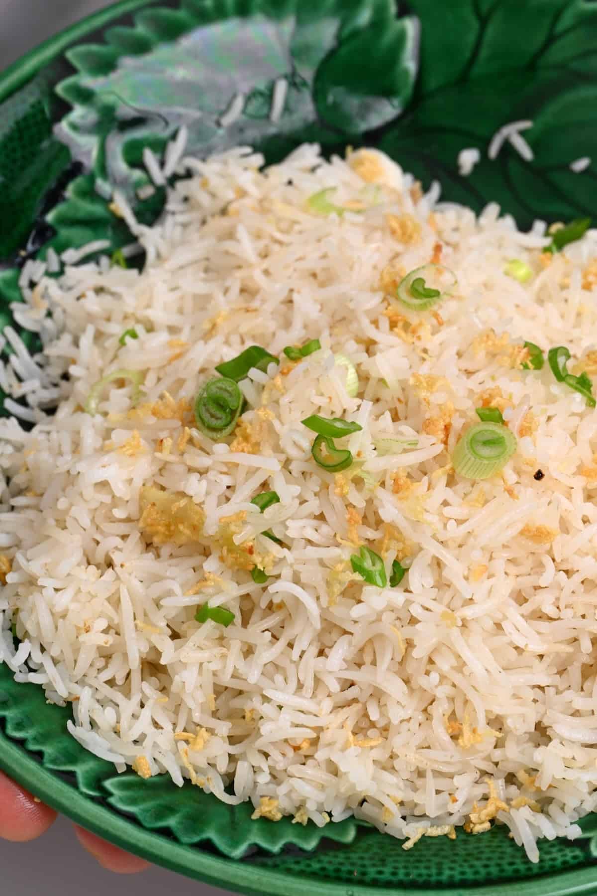 Close up of garlic rice topped with green onion