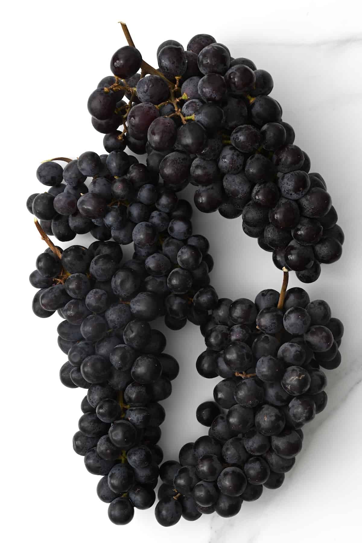 Black grapes on a flat surface