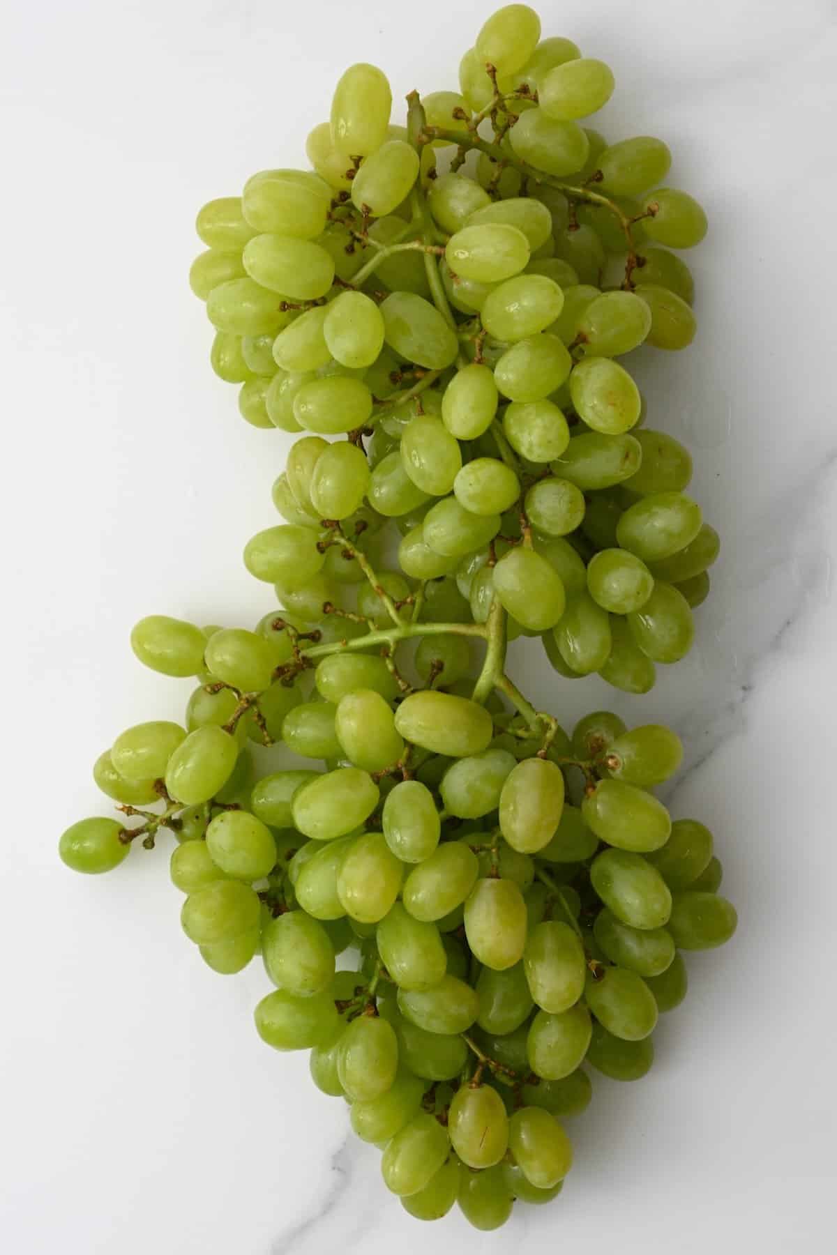 Green grapes on a flat surface