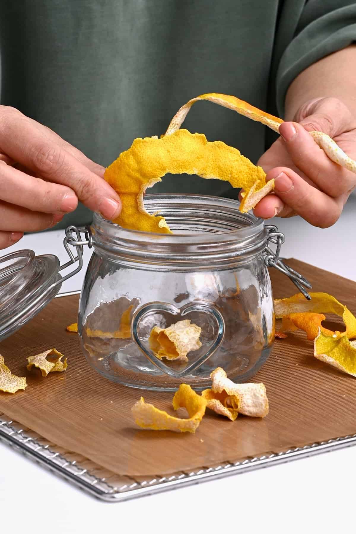 Storing deydrated lemon peel in a jar