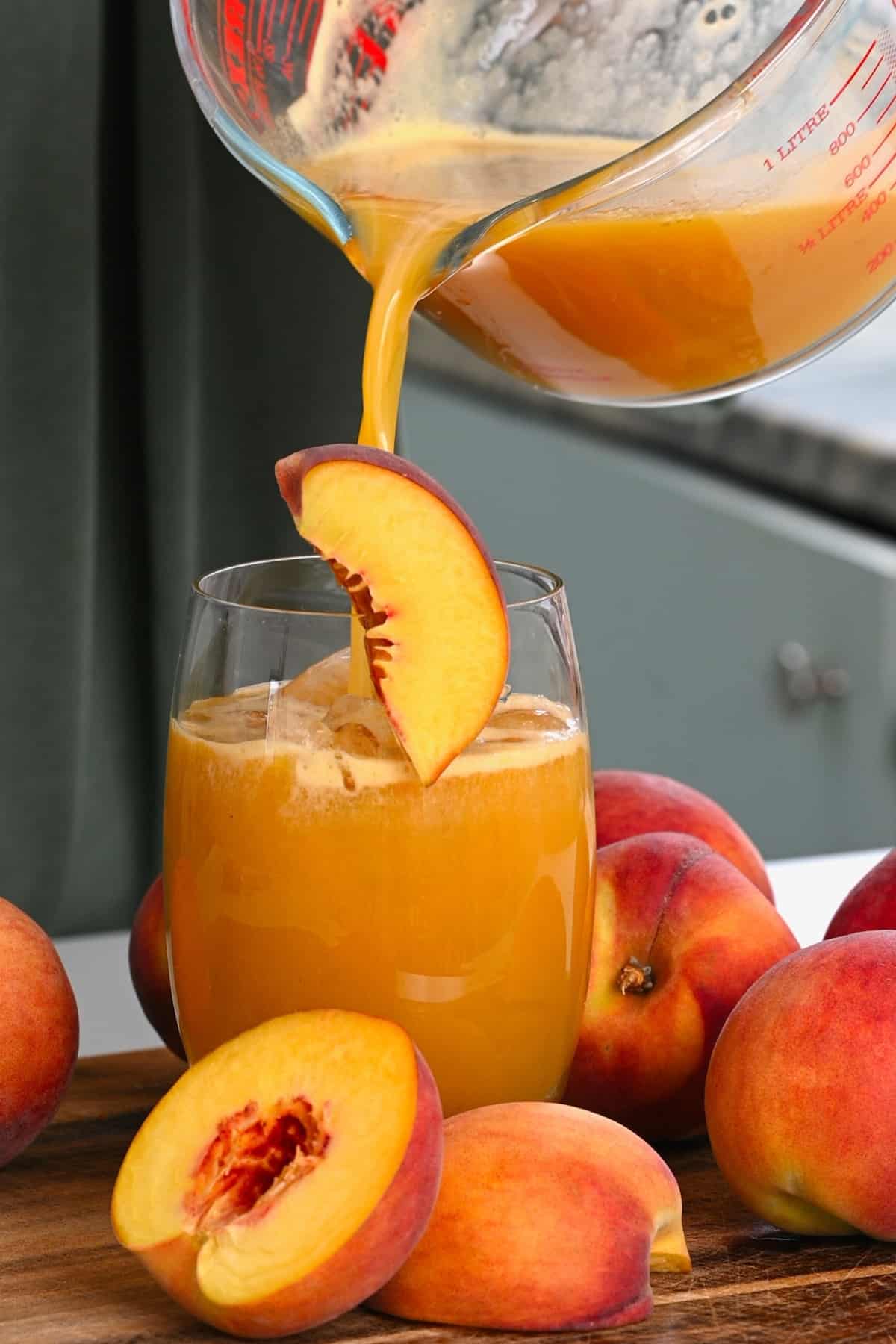 Pouring peach juice into a glass