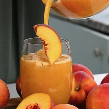 Pouring peach juice into a glass