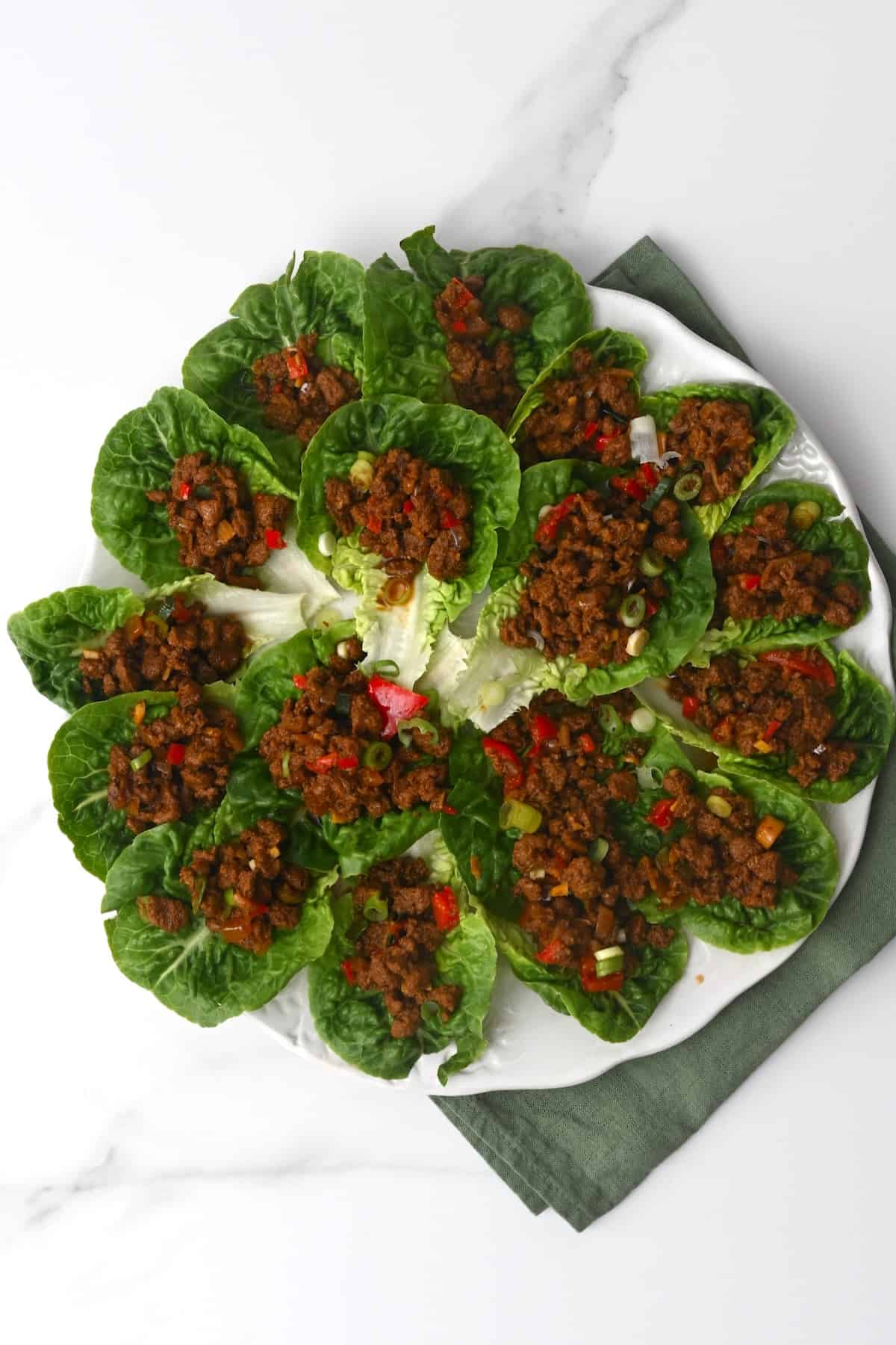 A plate with lettuce wraps on it