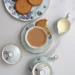 Milk tea in a cup and a biscuit next to it - 18