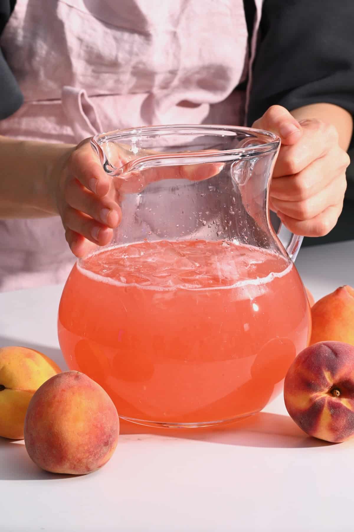 A large pitcher with peach lemonade