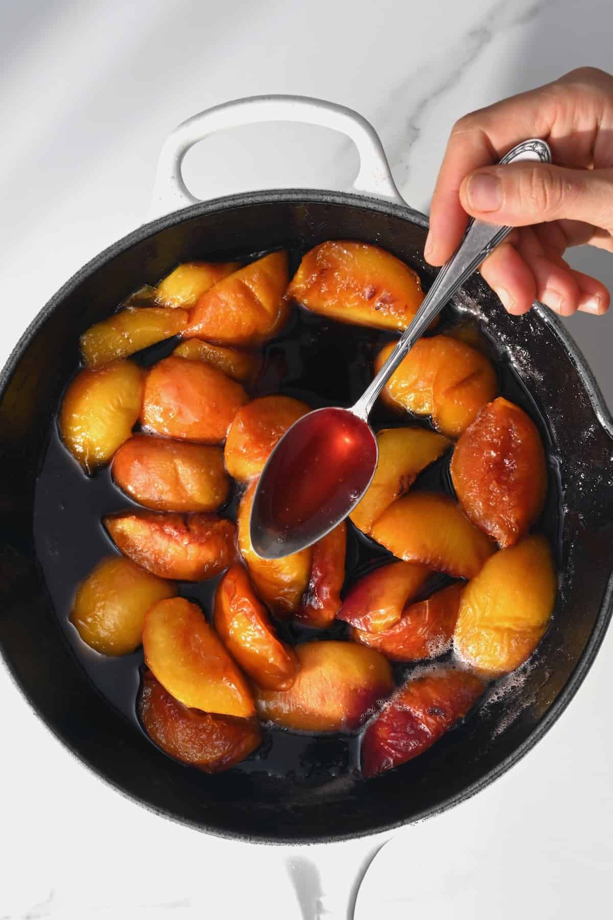 Making peach syrup in a pan
