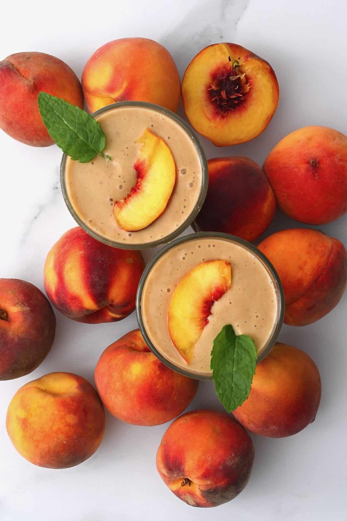 Top view of two glasses with peach smoothie