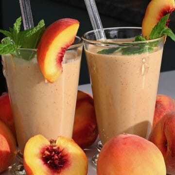 Two glasses with peach smoothie