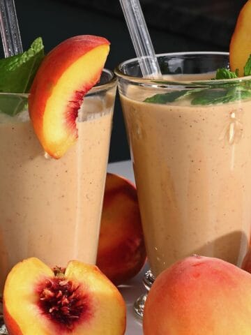 Two glasses with peach smoothie