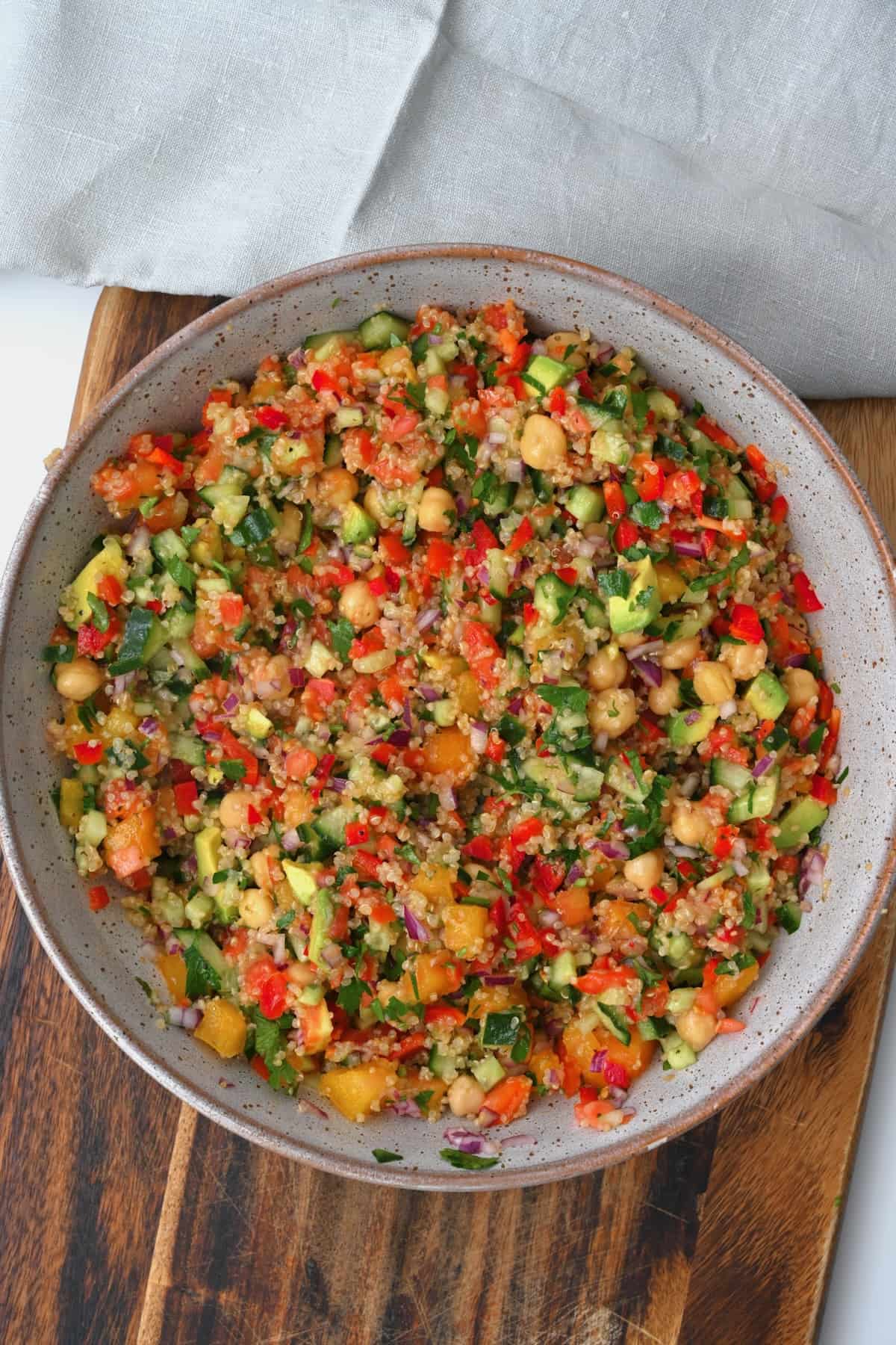 A bowl with quinoa chickpea and veggies salad