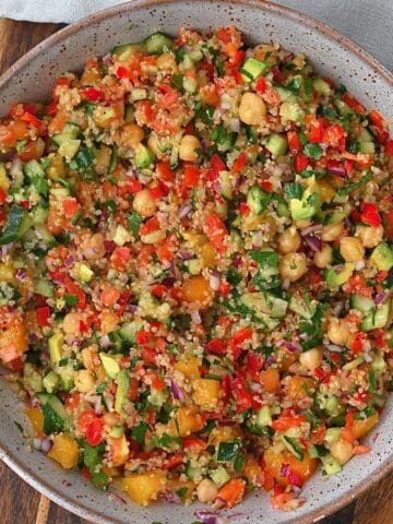 A bowl with quinoa chickpea and veggies salad
