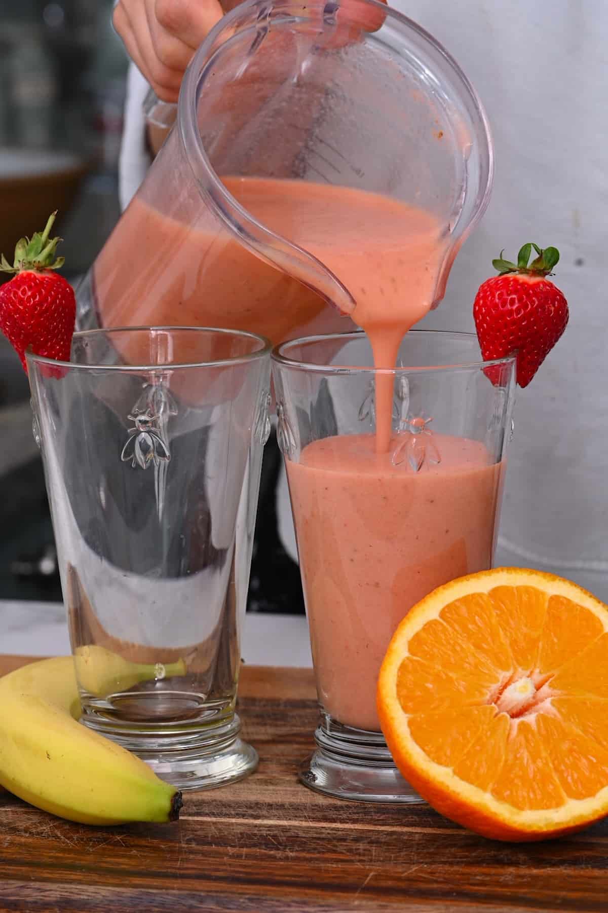 Pouring smoothie into a tall glass